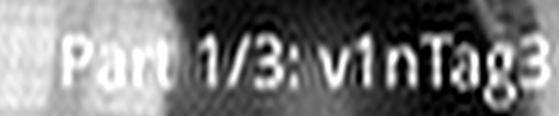 La banda del rótulo ya limpia: el texto blanco «Part 1/3: v1nTag3» sobre el fondo oscuro de la cara